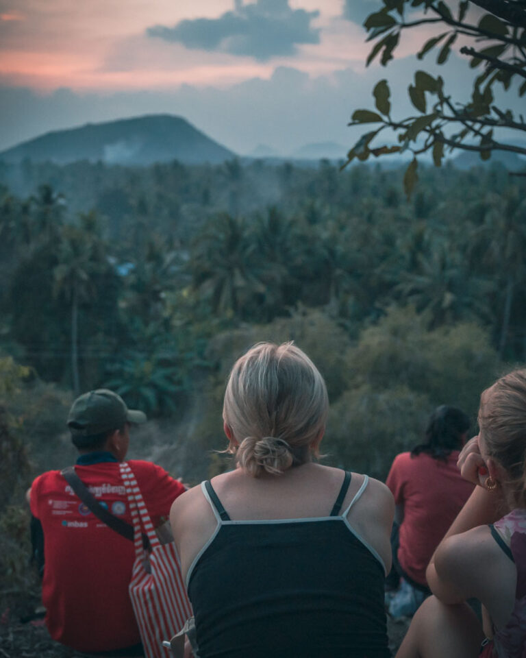 People watching bats at sunset
