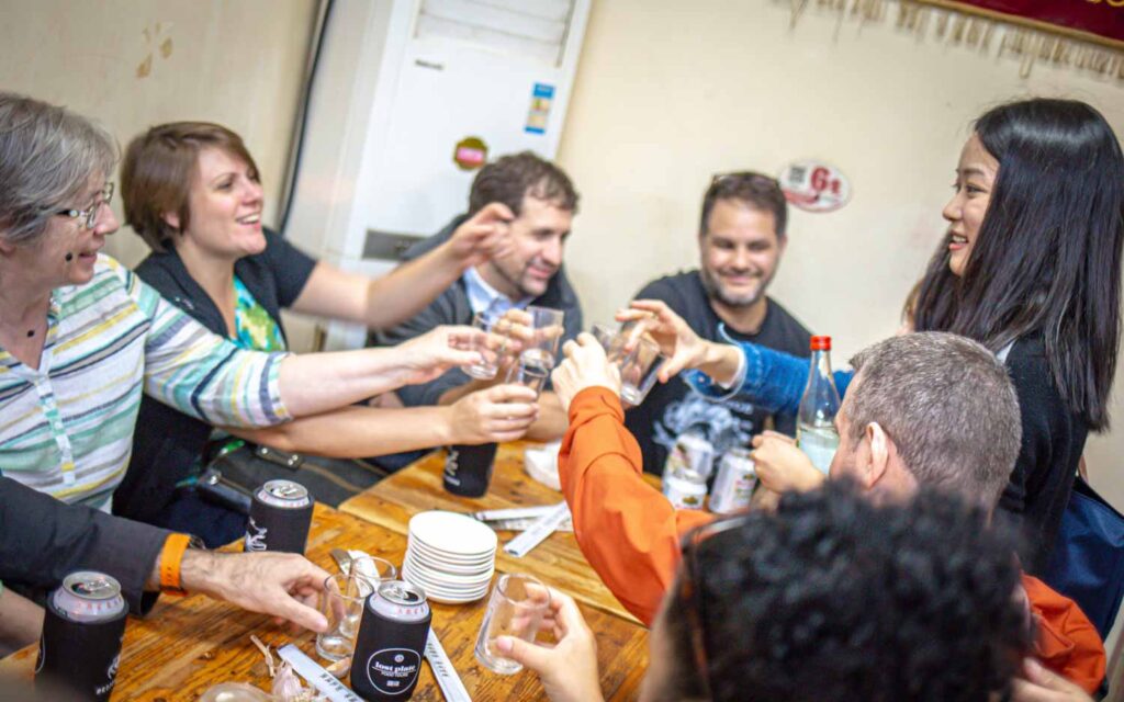 People enjoying food around a table