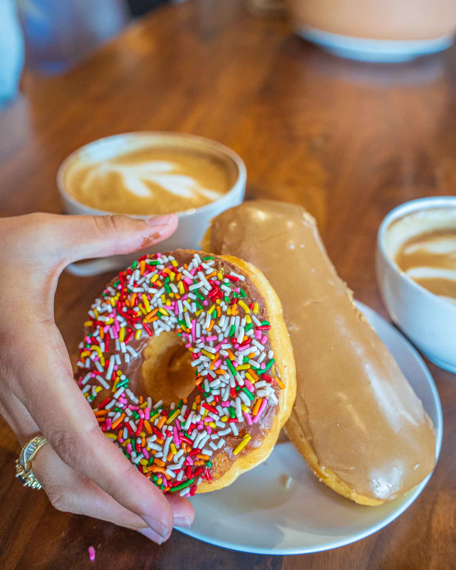 A plate of donuts with a specialty latte