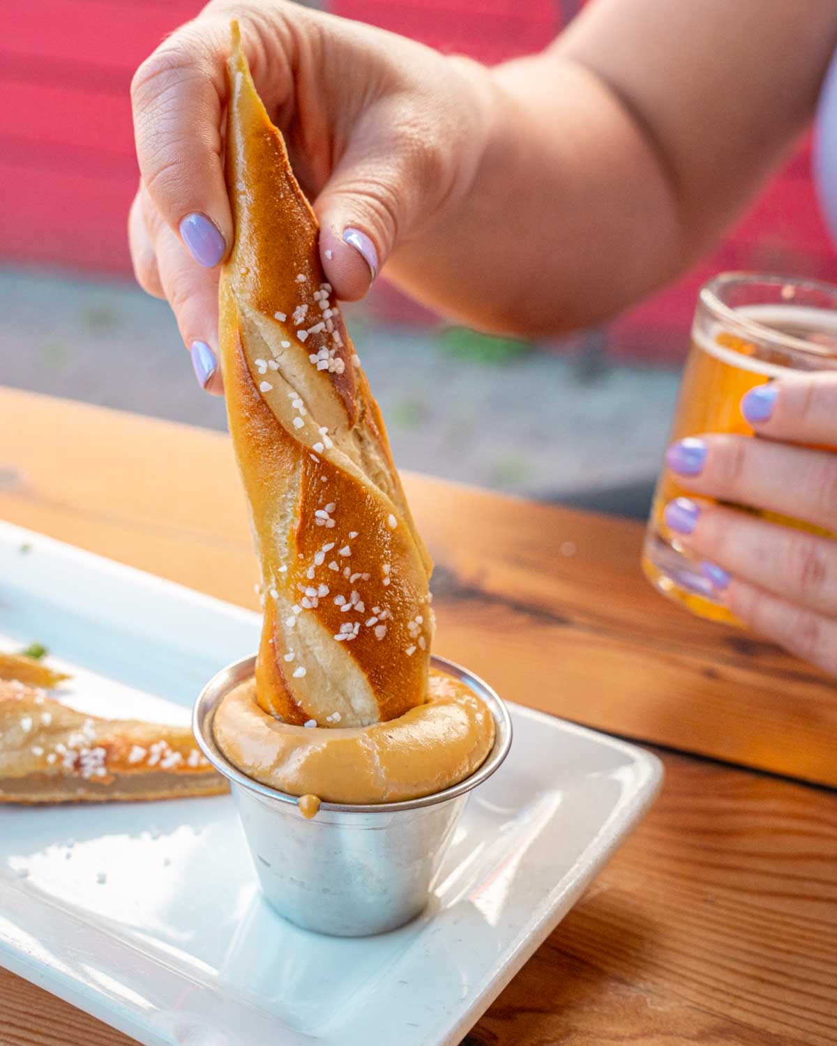 bar pretzel dipped in beer cheese