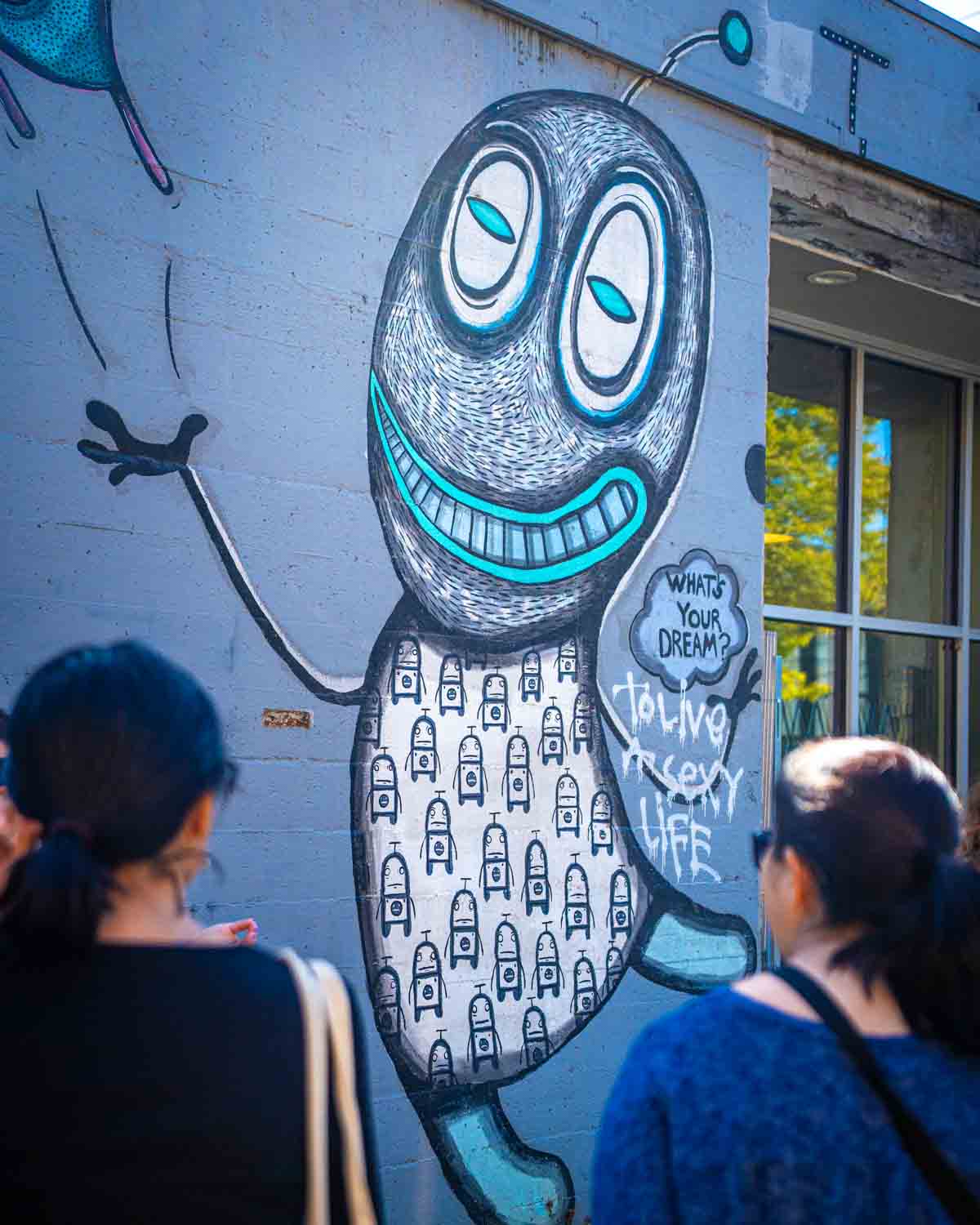 people looking at a Portland street art