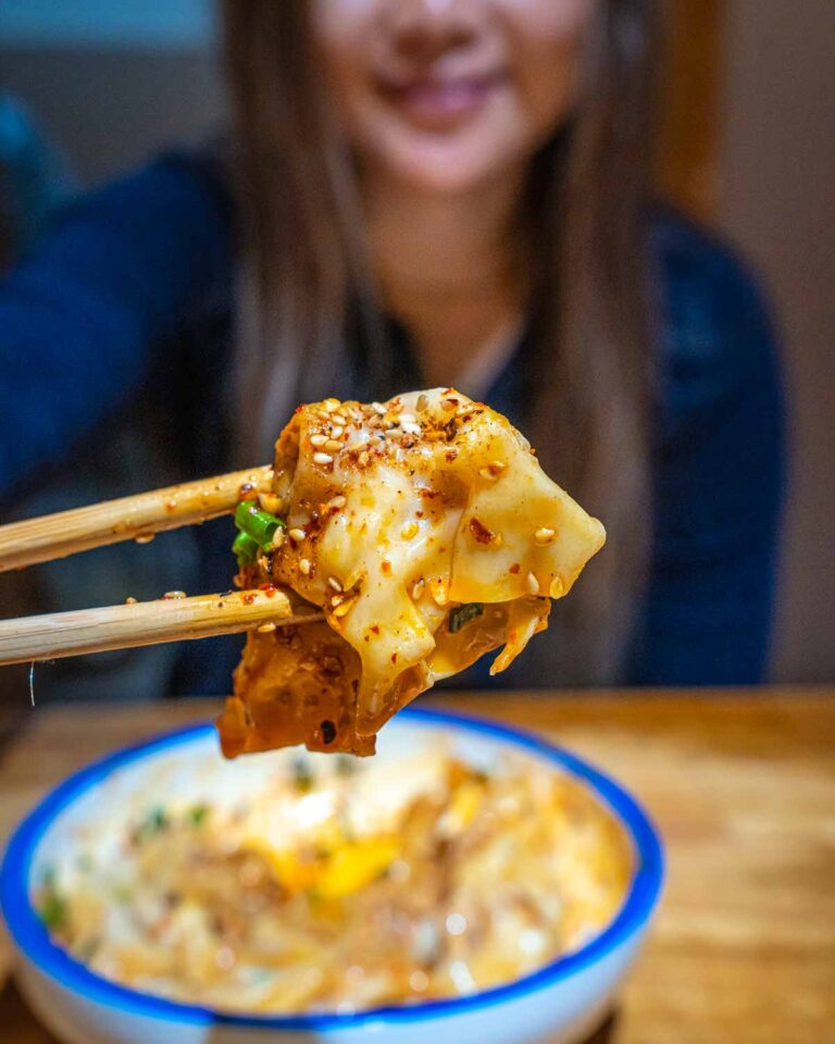 Chopsticks holding a Chaoshou dumpling