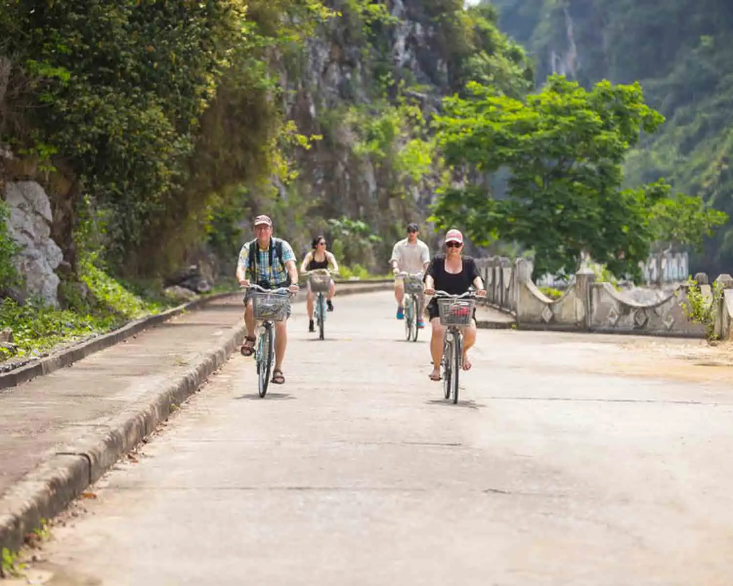 Guests cycling in village