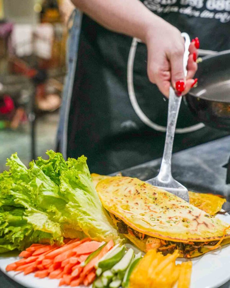 Guest flipping Bahn Xeo pancakes