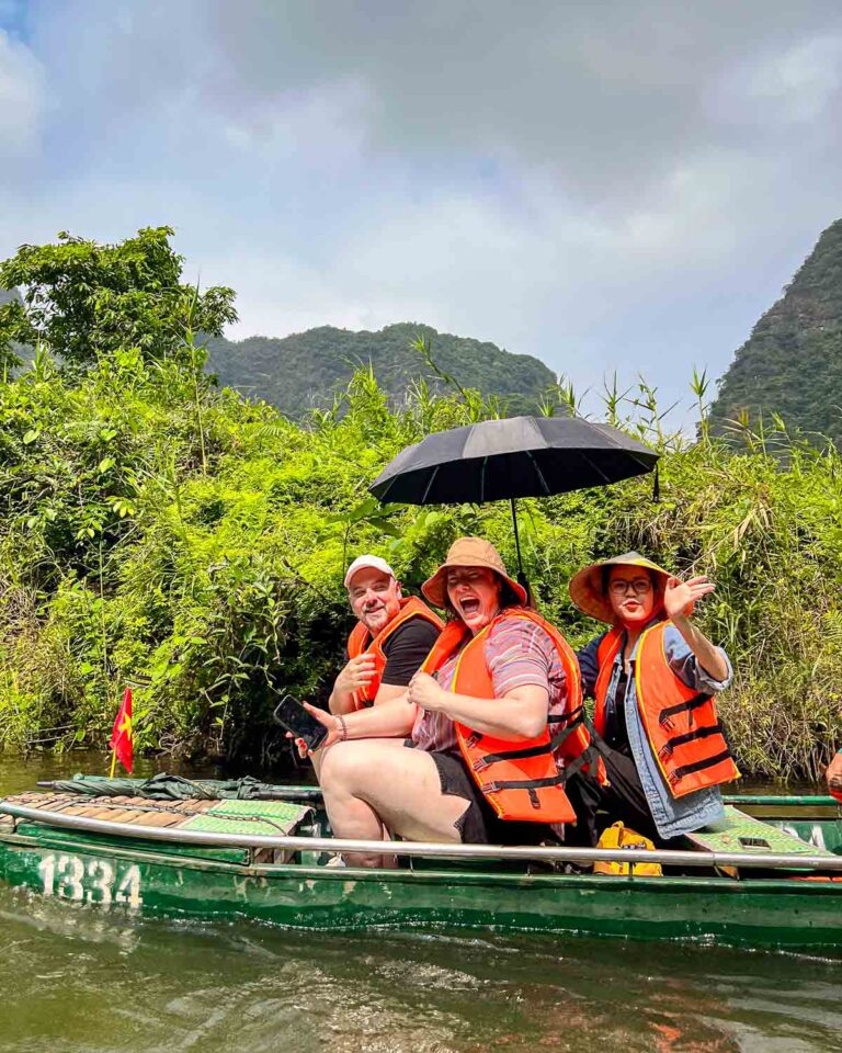 Happy guests waving from a boat