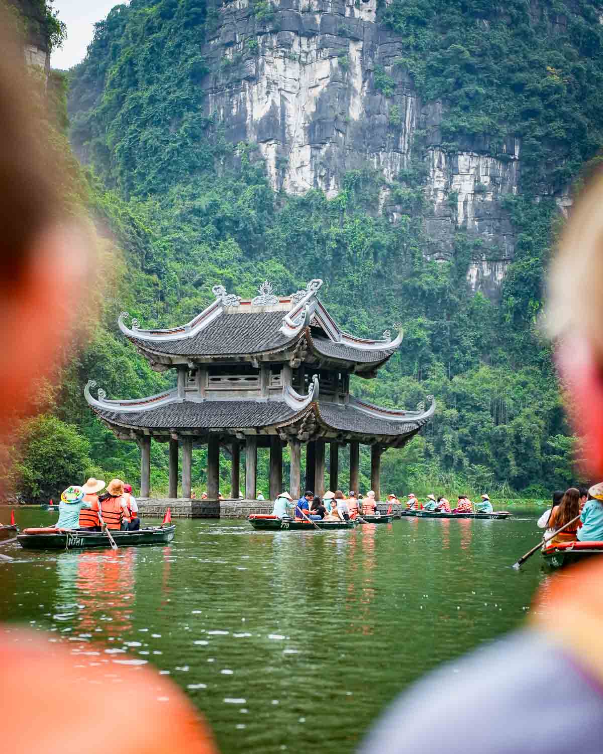 Paddling on a boat toward a floating pagoda