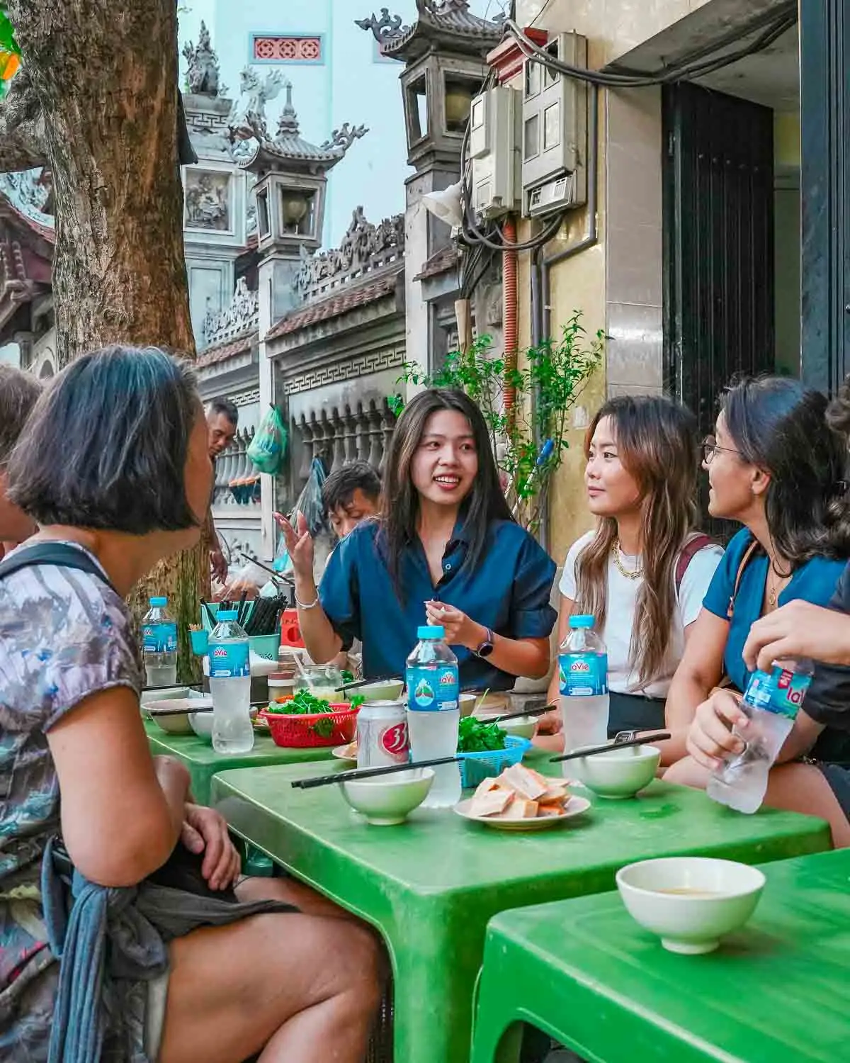 Guests listening to guide around a table
