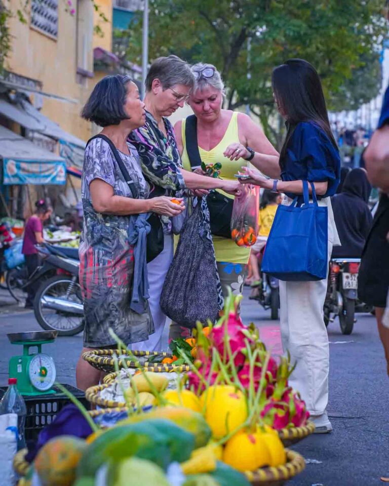 Guests trying market fruit