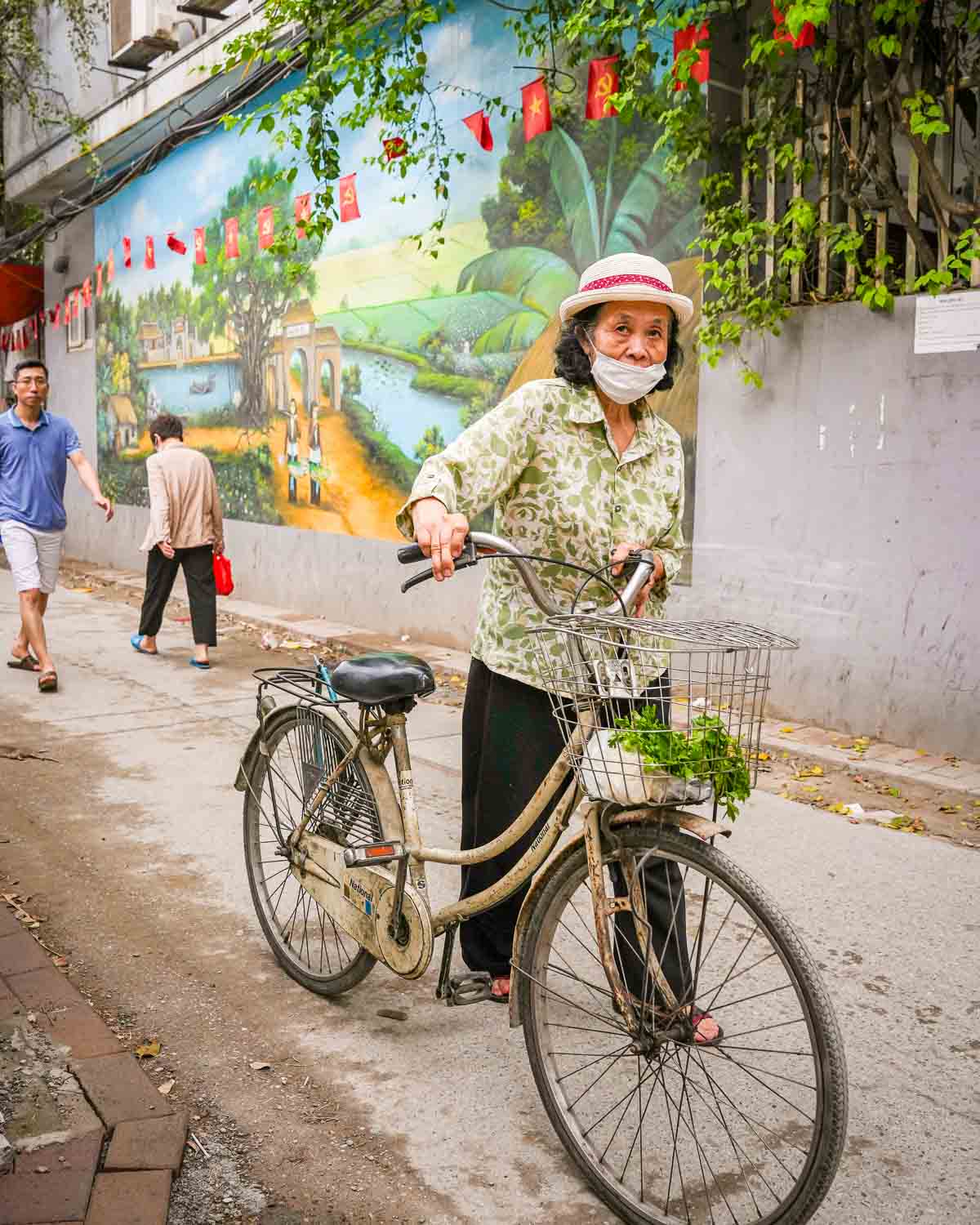 Local pushing bicycle in a small street