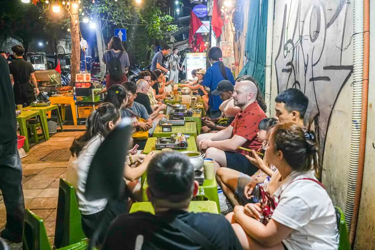 Locals eating outside on stools