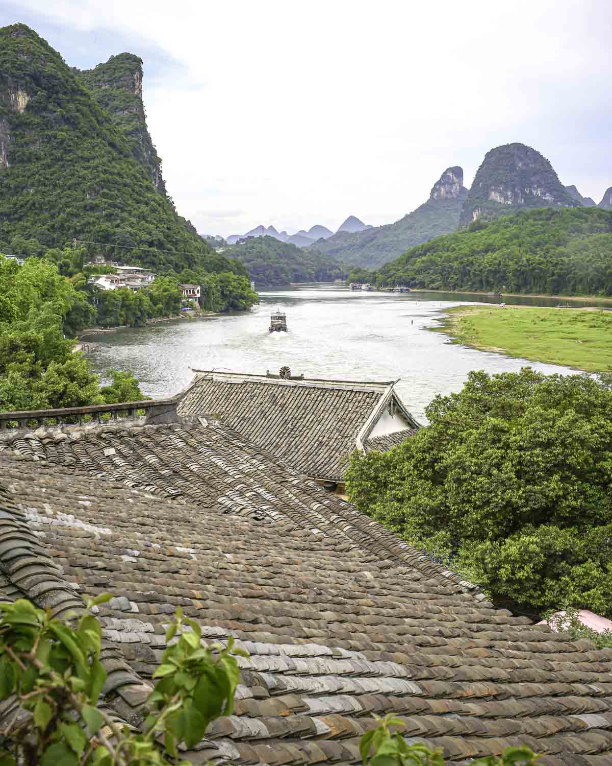 View of rooftops, river, and mountains