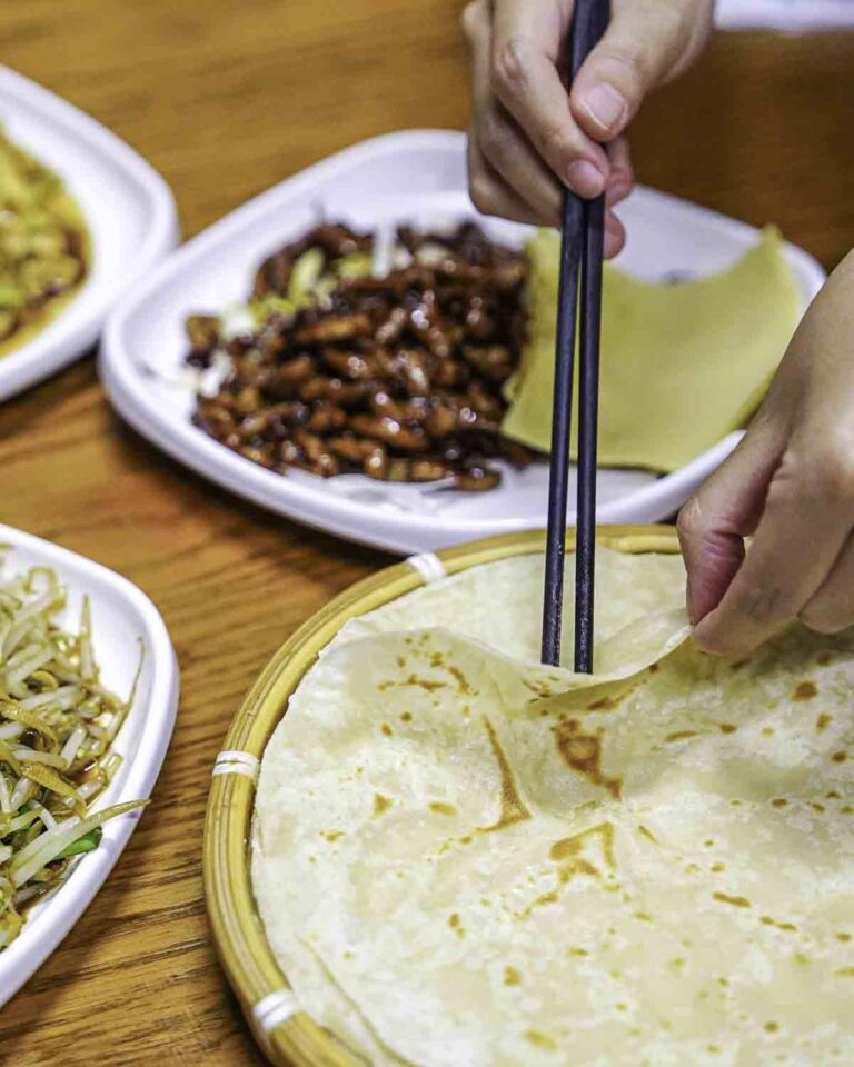 Hands pulling apart a spring pancake