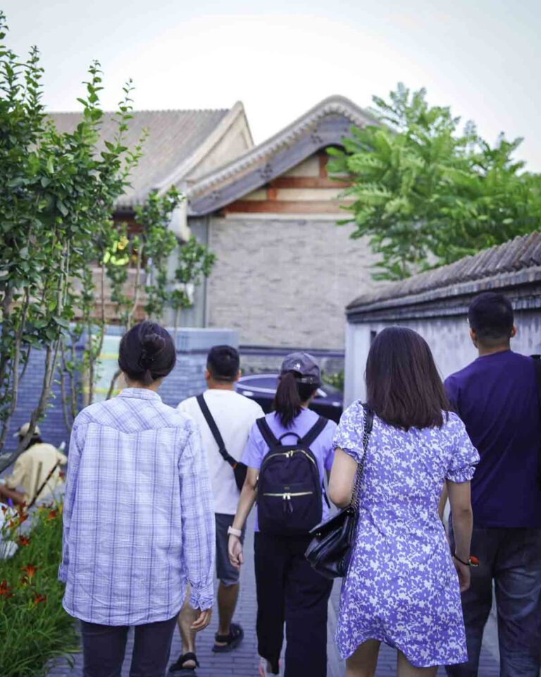 Guests walking through a hutong alley