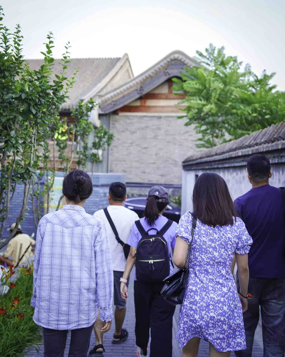 Guests walking through a hutong alley