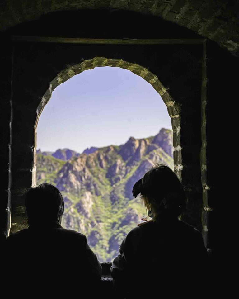 People looking out a window in a Great Wall watchtower