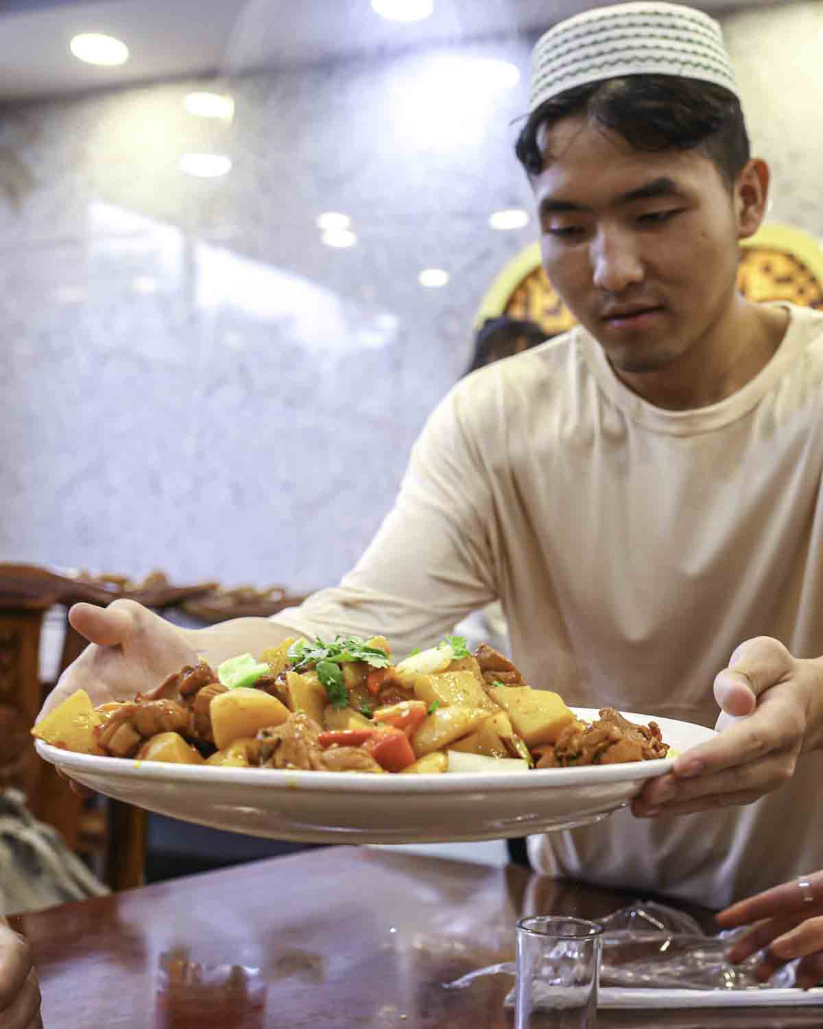 Xinjiang Chef holding Big Plate Chicken