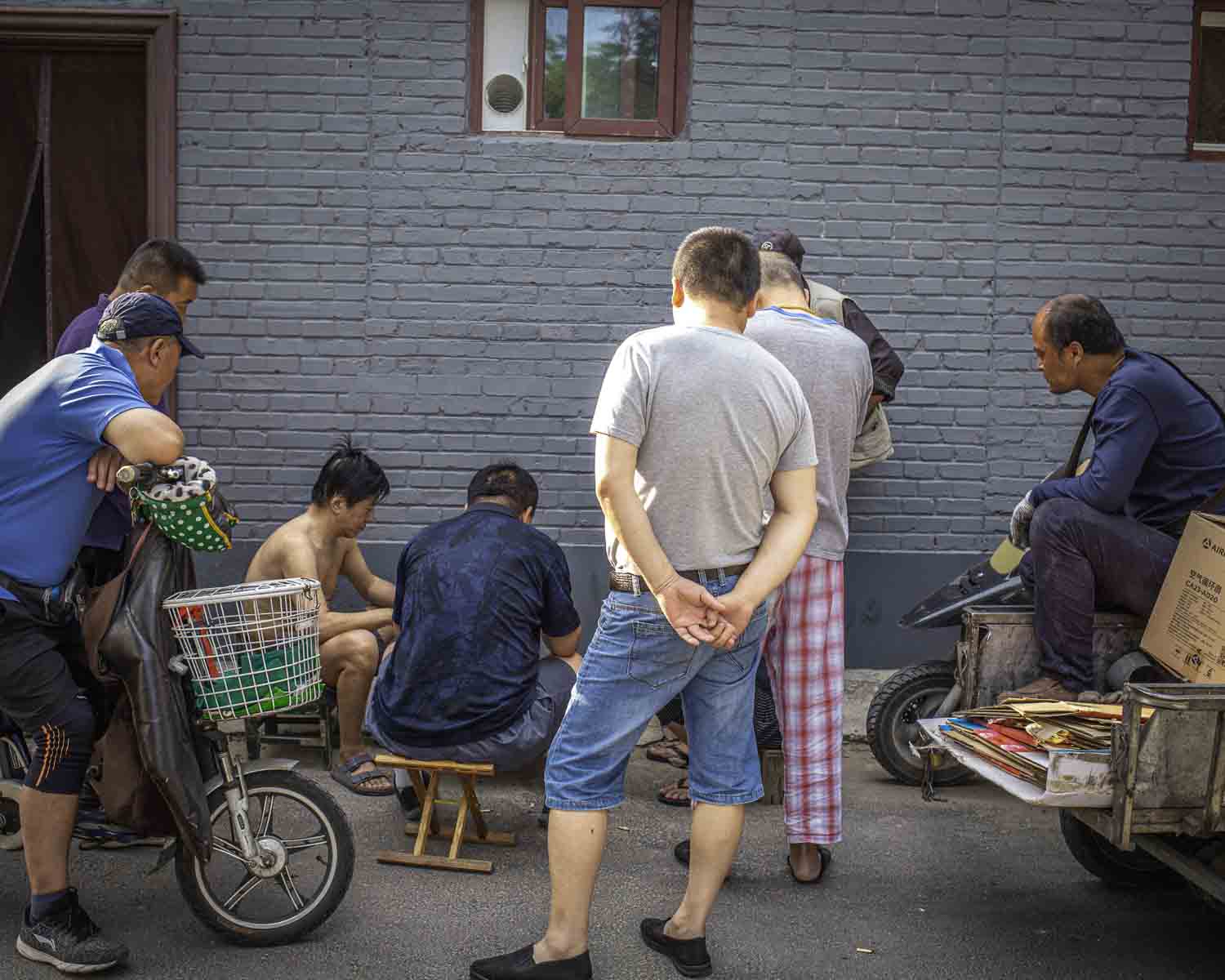 Locals playing cards in hutong