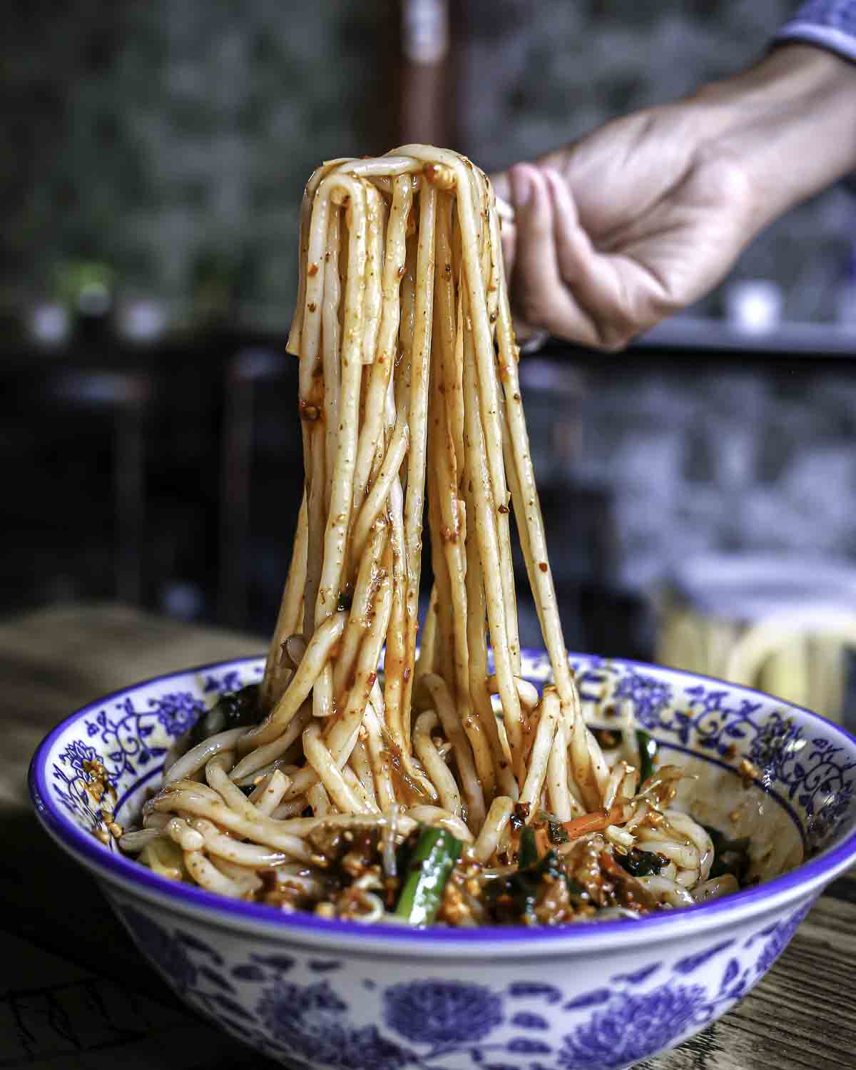 Pulling rice noodles out of a bowl