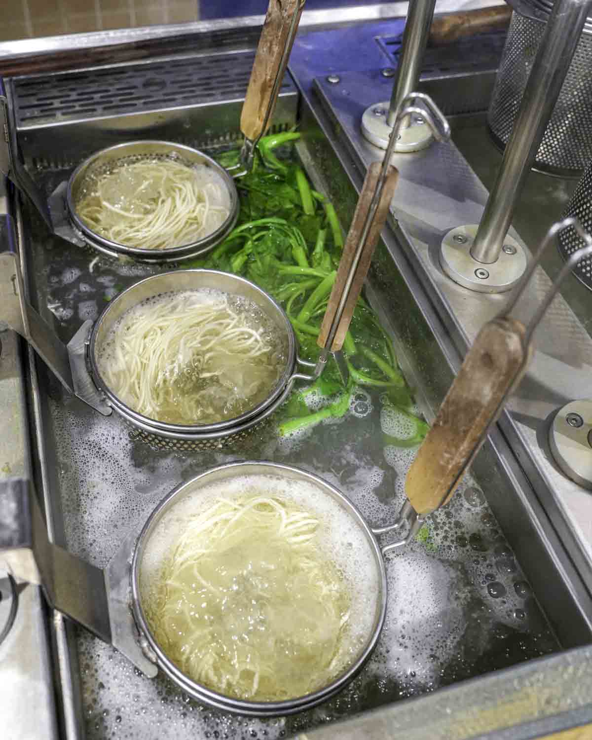 Noodles boiling in baskets