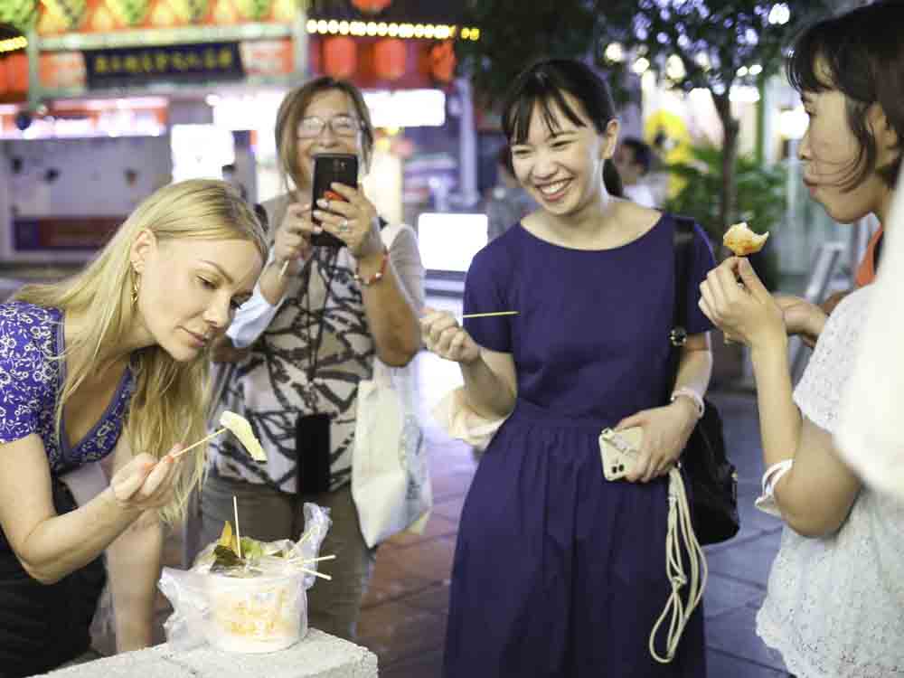 Happy guests eating street food