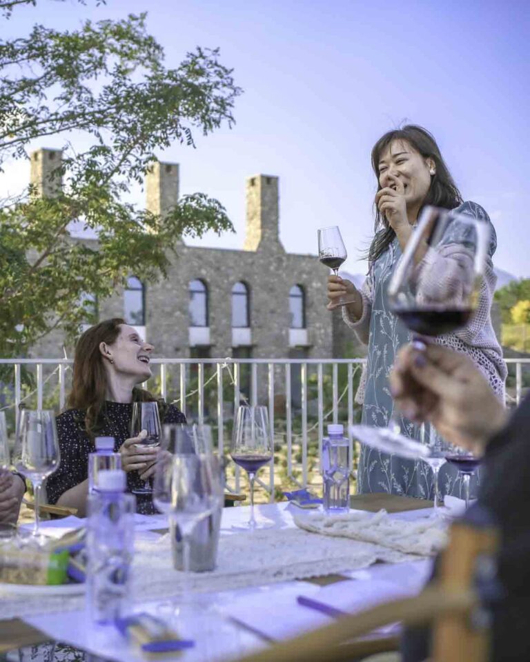 Guests wine tasting in front of Charme